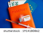 money euro banknotes passport, syringe and vaccine  international certificate of vaccination during coronavirus pandemic, vaccine availability in rich and poor countries. sale of medicines. 