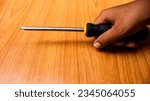Small photo of The man who wanted to justify the electronic equipment by using a screwdriver. Tool concept. Concept of justifying tools. Use for background