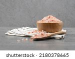 Himalayan pink salt in a wooden cup on a cloth
