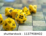 Small photo of Yellow dices for board or tabletop games on a rpg map