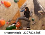 Teenager climbing a rock wall