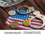 Golden Bitcoins Cryptocurrency with Handcuffs on Dollar bills. Digital crime, arrest or hacking concept. Handcuffs dollars and bitcoins on the table. Not legal mining