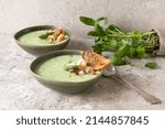 bowls of creamy spinach soup with shrimp on the table