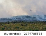 Small photo of Helicopter against wildfire during strong wind and drought