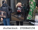 Small photo of NEW YORK, NY - MARCH 6, 2021: Animal rights activists holds a video careen with movies of trapped animals during a Canada Goose protest in front of Saks Fifth Avenue flagship Store.
