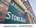 Small photo of Longton, Stoke on Trent, England, June 13th 2023. Joule's Stone Ales signage on a wooden door.