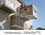 Small photo of View of a residential building in Israel during the holiday of Sukkot, in which temporary, wooden structures are placed on balconies as part of the ritual observance of the weeklong Jewish festival.