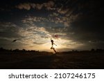 Silhouette Of Children Flying A ...