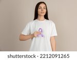 Small photo of Woman holding a purple ribbon in her hands ADD,ADHD,Alzheimer Disease ,Arnold Chiari Malformation,Childhood Hemiplegia stroke, Epilepsy, Chronic Acute Pain,Crohns