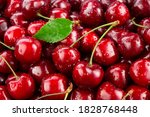 Cherries. Cherry background. Fruit background. Wet cherry with leaves and drops.