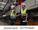 Small photo of A couple of Rail engineers shook hands in a Train Station after completing the job.