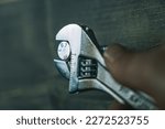 Small photo of Tightening a bolt with an adjustable wrench. Tightening a stainless steel lag bolt with a wrench.