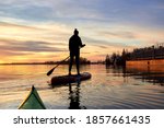 Silhouette Of Woman Paddle On...