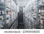 Small photo of Narrow pharmacy aisle flanked by towering shelves stocked with medicine boxes. A pharmacy robot navigates through, ensuring efficient and precise medication retrieval.
