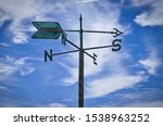 Small photo of weather vanes with letters indicating the points of the compass