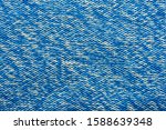 The texture of a knitted sweater. Blue white mottled pattern. Facial surface. Background. Copy space