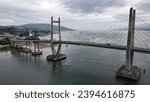 Small photo of A bridge over a river with a city in the background "JMP" in ambon City, Maluku Indonesia