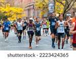 Small photo of New York NY USA-November 6, 2022 Runners pass through Harlem in New York near the 22 mile mark near Mount Morris Park in the running of the TCS New York City Marathon