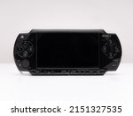 Small photo of Madrid, Spain; 04-30-2022: Front view of the famous Sony PSP (Playstation Portable) video game console in black on a white background