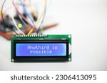 Small photo of A blue LCD display showing the positive message 'Anything is possible' with wires coming from a computer circuit board in the background.