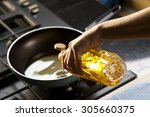 Pouring vegetable oil into frying pan
