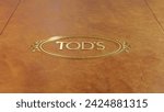 Small photo of Marche, Italy - 02.13.2024: Tod's gold logo on leather