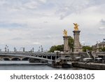 Small photo of Alexander III Bridge, Beaux Arts style, crosses the Seine River as it passes through Paris and connects the Esplanade des Invalides with the Grand Palais and the Petit Palais, Paris, France
