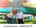 Mother and her son in the museum of aviation, and shows him on a plane in the sky