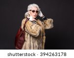 Pret-a-Porter or High Fashion. Portrait of old model posing for Roberto Cavalli project in studio. Beautiful lady resembling actress from Devil wears Prada.