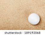 Golf Ball On The Sand Background