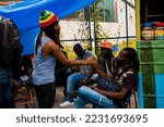 Small photo of St Andrew, Jamaica January 01, 2022: Rastafatian Reggae Artiste Jah Izrehl parades through a poor people market in Papine Jamaica