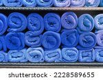 blue towel roll stack on shelf