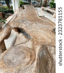 Small photo of Long wooden table of large shapeless tree pieces