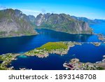 Stunning view point of mountains and blue sea at Reinebringen, Lofoten islands. Scenery of Reine fishing village. One of most popular hiking trails in North of Norway. Nature background