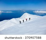 A group of people randonee ski walking high above the fjords. Lyngen Alps, Norway