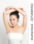 Small photo of Beautiful Young Asian woman lifting hands up to show off clean and hygienic armpits or underarms on white background, Smooth armpit cleanliness and protection concept