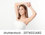 Small photo of Beautiful Young Asian woman lifting hands up to show off clean and hygienic armpits or underarms on white background, Smooth armpit cleanliness and protection concept