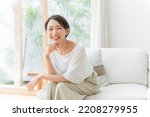 Middle-aged Asian woman relaxing at home