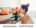 Woman Smelling Fresh Roses In...