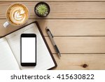 Office desk with blank screen smartphone,pen,notebook and coffee cup on  wood table.Top view with copy space.Office supplies and gadgets on desk table.Working desk table concept.Flat lay image.