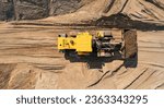 Small photo of Yellow Industrial excavator working on sand quarry. Aerial top view open pit mine industry concept.