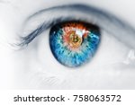 Eye of a person with the bitcoin coin logo in the pupil