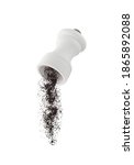 Small photo of Milled black pepper falling from flying ceramic pepper shaker isolated on white