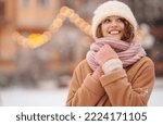 Beautiful woman outdoor during christmas time in front of christmas lights. Holidays, rest, travel concept.