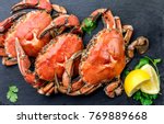 Cooked crabs on black plate...