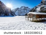 Beautiful, panoramic view to the snow covered lake Lago Di Braies, Pragser Wildsee, in the Italian Dolomites during a cold winter morning
