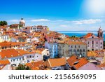 The beautiful skyline of Lisbon, Portugal, with red roofed, colorful houses in the Alfama district during a sunny day