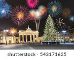 Brandenburg Gate in Berlin, Germany, with fireworks and Christmas tree