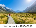 Asian woman enjoy travel at Mt cook national park in South Island New Zealand, Summer Time, concept of woman solo travel and relaxation moment
