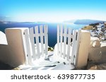 Small photo of Open door in summer, vacation background. Oia village, Santorini, Greece, Europe location, famous and popular summer resort. White and blue color gamut photo, traditional Greek colors.